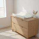 Leaf Anti-Roll Wedge Baby Changing Mat on an Oak Changing Unit in a White Nursery | Baby Bath Time Essentials - Clair de Lune UK