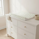 Leaf Anti-Roll Wedge Baby Changing Mat on a white changing unit in a bright white nursery | Baby Bath Time Essentials - Clair de Lune UK