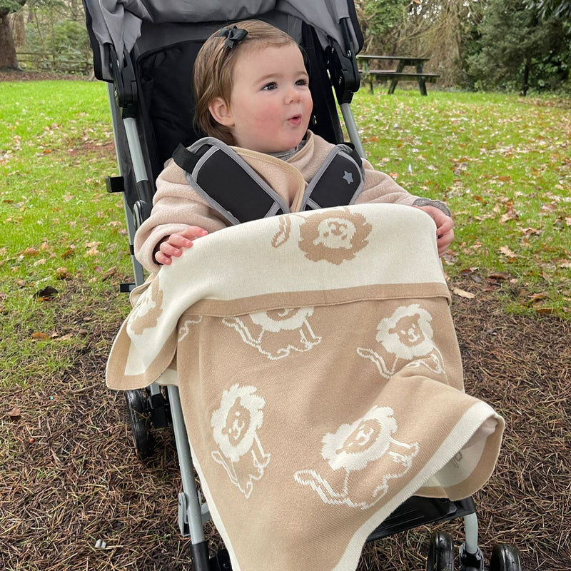 Baby cosy in the Reversible Lion Knitted Blanket | Cosy Baby Blankets | Nursery Bedding | Newborn, Baby and Toddler Essentials - Clair de Lune UK