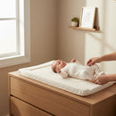Mum tending to baby on the East Coast Little and Loved Changing Mat on an Oak changing unit in a luxury minimalist nursery | Bathing & Changing Essentials - Clair de Lune UK