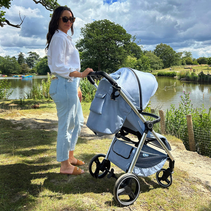 Mom pushing the My Babiie MB160 Dani Dyer Blue Plaid Pushchair in summer | Buggies, Strollers & Pushchairs | Travel With Your Baby - Clair de Lune UK