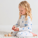 Toddler playing with wooden bricks wearing the Grow Grows Organic Marvellous Moons Sleepsuit | Baby Grows and Onesies | Organic Baby Clothes - Clair de Lune UK