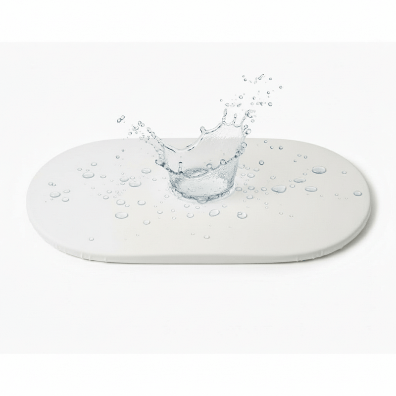 Splash on the Moses Basket Mattress Protector to Show that it's water resistant | Soft Baby Sheets | Moses Basket Bedding - Clair de Lune UK