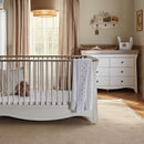 White CuddleCo Clara Luxe 2 Piece Furniture Set - Cot Bed and Changer Dresser in a cosy beige and brown nursery | Nursery Furniture - Clair de Lune UK