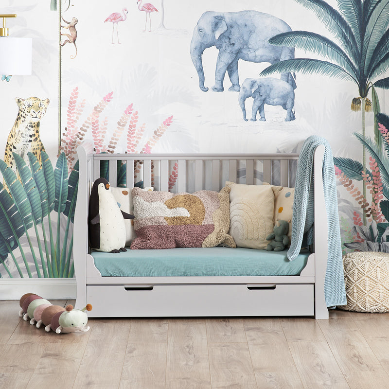 The cot bed of the warm grey Obaby Stamford Mini Sleigh Cot & Changing Unit in a jungle dream nursery room | Nursery Furniture Sets | Room Sets | Nursery Furniture - Clair de Lune UK