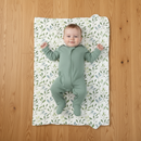 Baby lying on the Olive Foldable Travel Changing Mat laid out flat | Baby Change Mat | Bathing & Changing Essentials - Clair de Lune UK