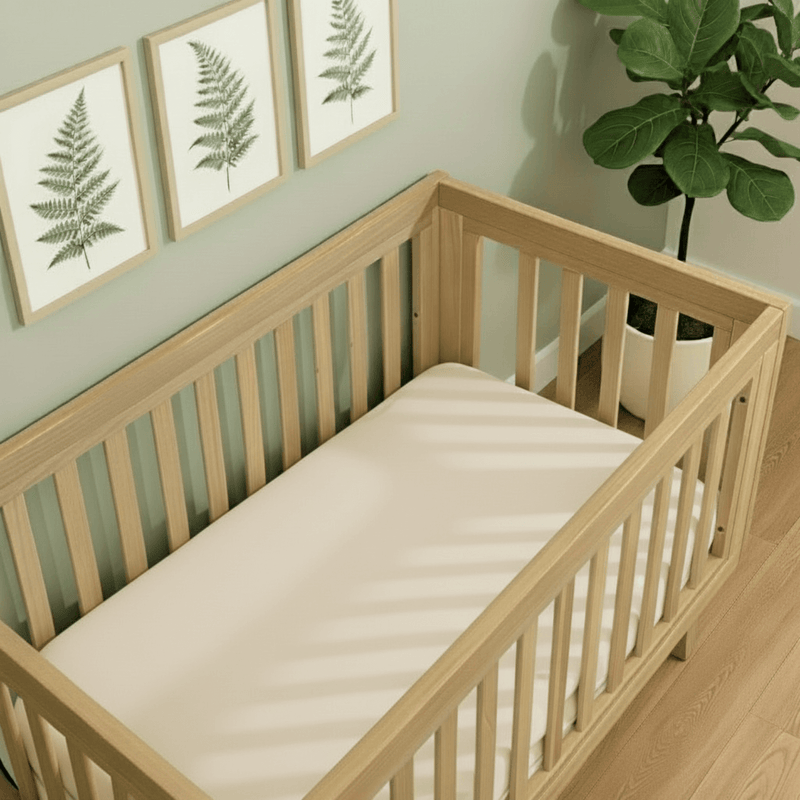 Cream 2 Pack Organic Cot Bed Sheet on the Oak Cot Bed | Soft Baby Sheets | Cot Bedding - Clair de Lune UK