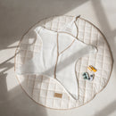  Cream Organic Star Breathable Mesh Baby Wrap Blanket laid out flat on the floor next to soft muslins and plants | Cosy Baby Blankets and Swaddles | Newborn Summer Essentials - Clair de Lune UK