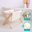 Cream Organic Folding Crib in a beige, natural nursery with large green plant showing the bundle with organic cellular blanket and organic | Bedside & Folding Cribs | Co Sleeper & Travel Cots | Nursery Furniture - Clair de Lune UK