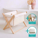 Cream Organic Folding Crib in a beige, natural nursery with large green plant showing the bundle with organic cellular blanket and organic | Bedside & Folding Cribs | Co Sleeper & Travel Cots | Nursery Furniture - Clair de Lune UK