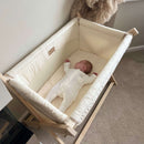 Baby lying on the Organic Folding Crib Fitted Sheets | Bedside & Folding Crib Accessories | Soft Baby Sheets | Nursery Linen - Clair de Lune UK