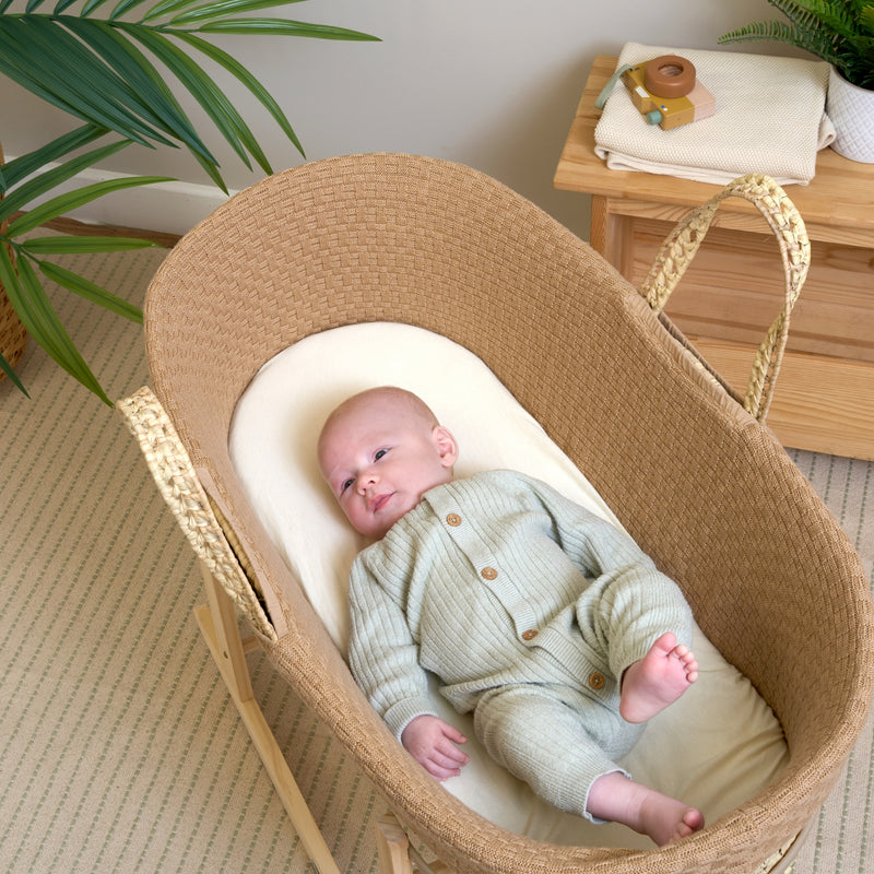 Baby sleeping in the Biscuit Brown Organic Knitted Palm Moses Basket in a neutral beige nursery | Moses Baby Baskets, Bassinets | Organic Baby Essentials | Nursery Furniture - Clair de Lune UK