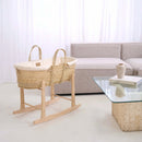 Clair de Lune Organic Moses Basket Bedding Set with Palm Basket and Rocking Stand in an Minimalist Living room with grey corner sofa and glass coffee table |  Moses Baby Baskets & Bassinets | Nursery Furniture - Clair de Lune UK