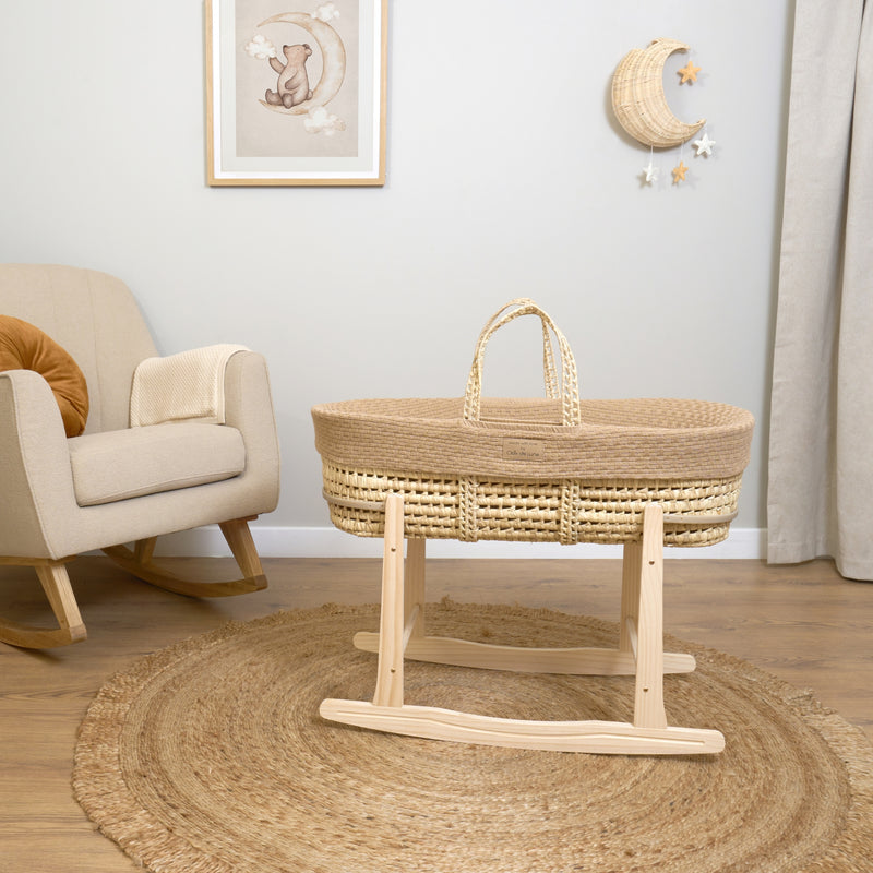 Biscuit Brown Organic Knitted Palm Moses Basket on natural rocking stand next to a boucle rocking chair in a neutral nursery | Moses Baby Baskets, Bassinets | Organic Baby Essentials | Nursery Furniture - Clair de Lune UK