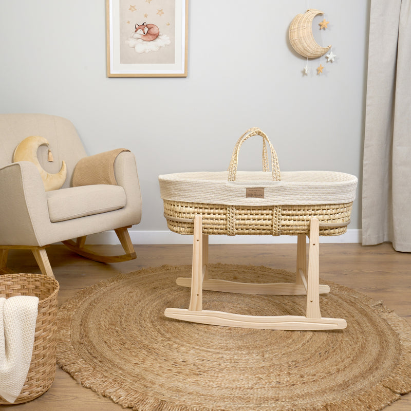 Cream Organic Knitted Palm Moses Basket on natural rocking stand by the boucle nursing chair in a beige neutral nursery| Moses Baby Baskets, Bassinets | Organic Baby Essentials | Nursery Furniture - Clair de Lune UK