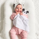 Baby in the pink ribbed sleepsuit holding the GrowGrows Panda Animal Comforter - Clair de Lune UK
