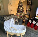 Dimple Palm Moses Basket by the fire in a cosy living room decorated for christmas | Baby's First Christmas | Gifts for Christmas Baby - Clair de Lune UK