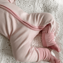 Close up of baby wearing the pink Grow Grows Organic Pinstripe Sleepsuit | Baby Grows and Onesies | Organic Baby Clothes - Clair de Lune UK