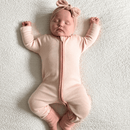 Baby wearing the Pink Grow Grows Organic Pinstripe Sleepsuit | Baby Grows and Onesies | Organic Baby Clothes - Clair de Lune UK