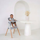 Toddler sat in the Grey Playtime High Chair next to a dining table in an ultra stylish kitchen | Feeding & High Chairs | Nursery & Kids Furniture - Clair de Lune UK