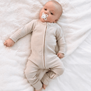 Newborn wearing the Cashmere Grow Grows Organic Ribbed Baby Sleepsuit lying on white sheet | Baby Sleep Wear | Children's pyjamas - Clair de Lune UK