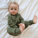 Baby wearing the Forest Grow Grows Organic Ribbed Baby Sleepsuit lying on a white cot sheet | Baby Sleep Wear | Children's pyjamas - Clair de Lune UK