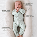 Baby wearing the Sage Ribbed Sleepsuit made from bamboo and organic cotton from GrowGrows with key features highlighted - Clair de Lune UK