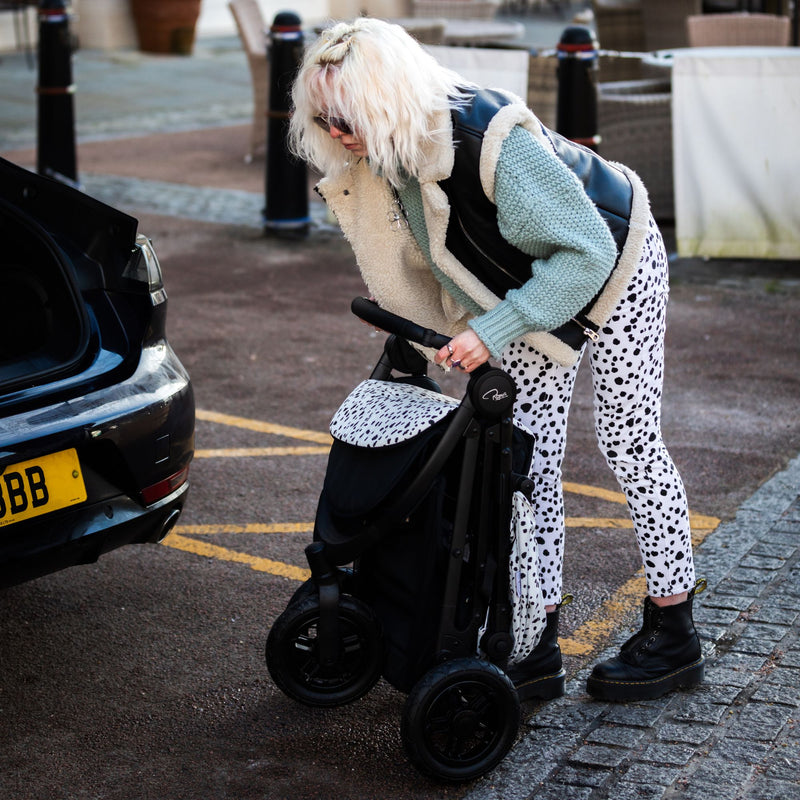 Mum folding her Dalmatian Roma Atlas 3 Wheel Pram | Strollers, Pushchairs & Prams | Pushchairs, Carrycots & Car Seats Baby | Travel Essentials - Clair de Lune UK