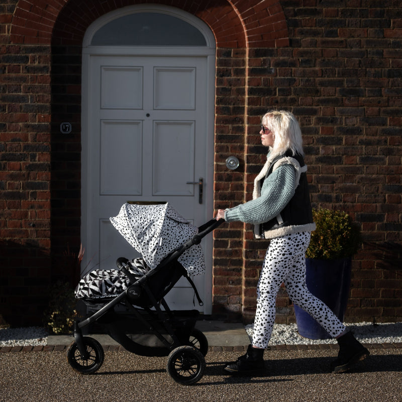 Mum walking back home with her kid sitting on the Dalmatian Roma Atlas 3 Wheel Pram | Strollers, Pushchairs & Prams | Pushchairs, Carrycots & Car Seats Baby | Travel Essentials - Clair de Lune UK