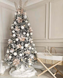 Scandi Palm Moses Basket by a beautifully decorated Christmas tree | Baby Christmas Gifts - Clair de Lune UK