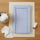 East Coast Blue Seashell Changing Mat laid flat on an oak floorwith nappy changing essentials | Bathing & Changing Essentials - Clair de Lune UK