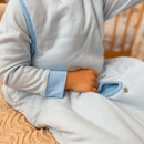 Close up of Toddler wearing the Blue Grow Grows Organic Pinstripe Sleepsuit and sleeping bag | Baby Grows and Onesies | Organic Baby Clothes - Clair de Lune UK