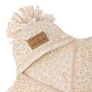 A close up of the tassel hood and 'Made with Love by Clair de Lune' faux suede label on the Leopard Star Fleece Baby Wrap Blanket with no buttons or zips on white background | Cosy Baby Blankets | Pram Blanket - Clair de Lune UK