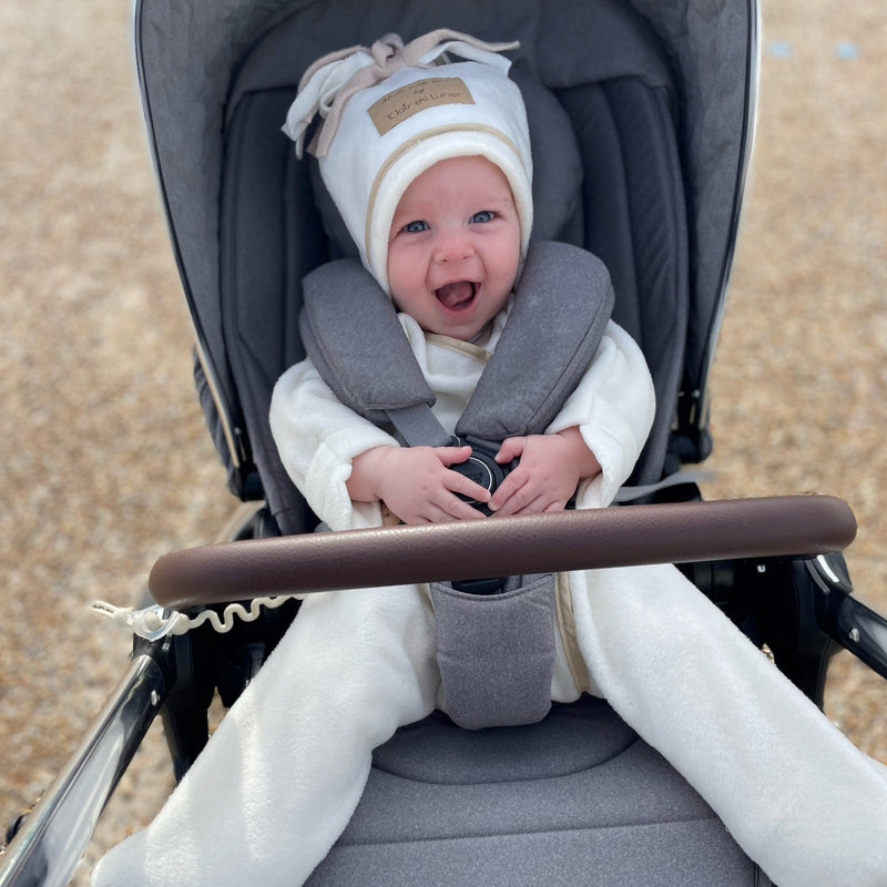 Baby wearing the cream Star Fleece Baby Wrap Blanket while staying in his pushchair | Cosy Baby Blankets | Nursery Bedding | Newborn, Baby and Toddler Essentials - Clair de Lune UK