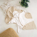 Cream Star Hooded Baby Towel laid flat on muslins by a jute rug | Bath Time Essentials | Newborn Hooded Towel - Clair de Lune