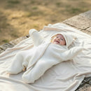  Baby wearing the Cream Sunny Day Organic Star Breathable Wrap in a summer garden | Cosy Baby Blankets and Swaddles | Newborn Summer Essentials - Clair de Lune UK