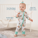 Toddler girl stood next to her cot wearing the GrowGrows Organic Tropical Turtles Sleepsuit with key features | Baby Grows and Onesies | Organic Baby Clothes - Clair de Lune UK