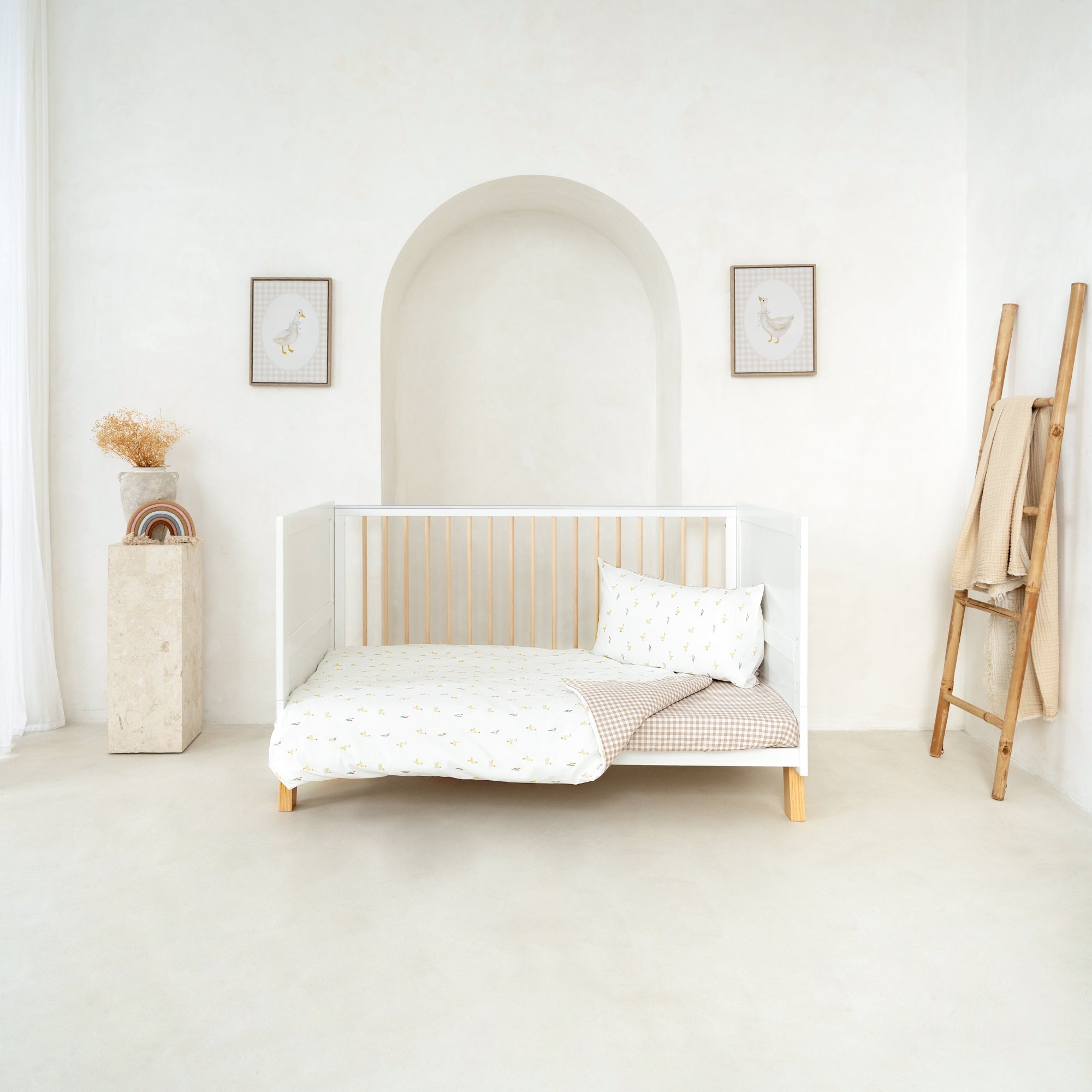 Reversible Little Duckling Cot Bed Duvet Cover and Pillowcase Set on the Essentials Cot Bed in a white minimalist nursery | Toddler and Baby Bedding | Nursery Linen - Clair de Lune UK