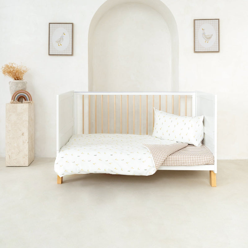 White Essentials Cot with Little Duckling Cot Bedding and Cot Bed Sheet in a bright white nursery | New Nursery Arrivals | Baby Bedding - Clair de Lune UK