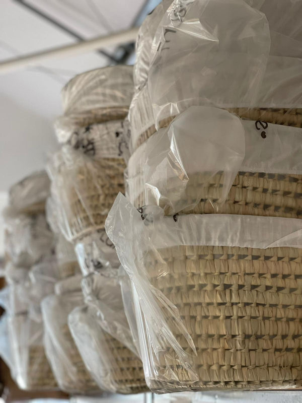 Palm Moses Basket donations piled up at the Baby Basics warehouse | Charity Partnerships - Clair de Lune UK