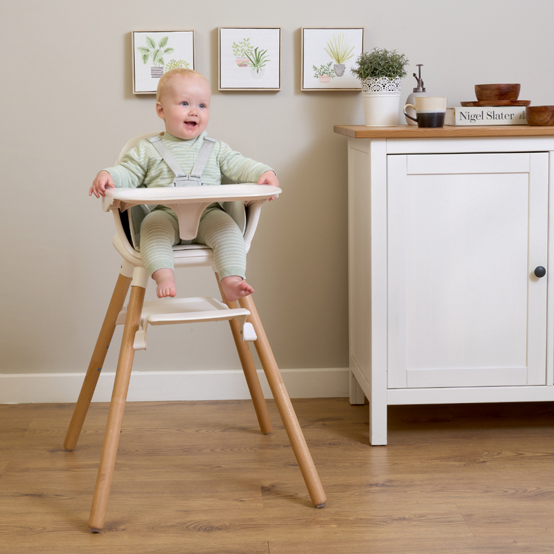 Gorgeous red headed boy sat in the white 6in1 High Chair in a farmhouse style white and oak kitchen | High chairs | Feeding & Weaning | Toddler Furniture - Clair de Lune UK