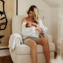Mum breast feeding her newborn in a cream bouclé nursing chair | Nursing and Feeding Chairs | Nursery Furniture - Clair de Lune UK