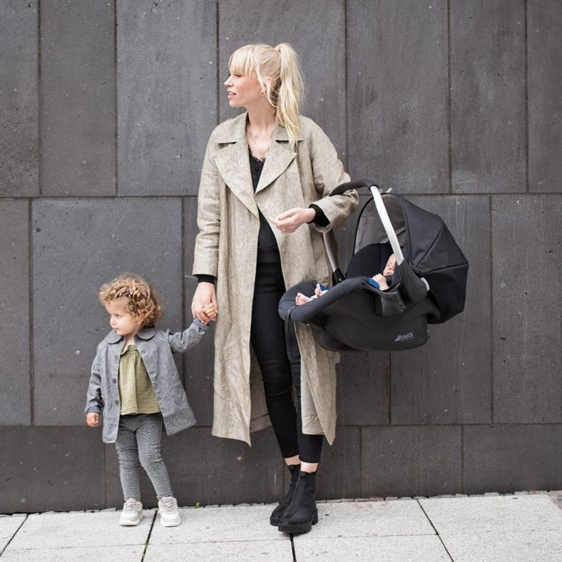 Mum carrying a car seat from the Hauck Rapid 4 Trio Travel System | Buggies, Strollers & Pushchairs | Travel With Baby - Clair de Lune UK