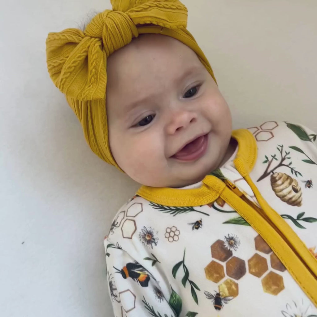 Close up on baby wearing the Grow Grows Honey Bees Organic Sleepsuit | Baby Grows and Onesies | Organic Baby Clothing - Clair de Lune UK