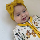 Close up on baby wearing the Grow Grows Honey Bees Organic Sleepsuit | Baby Grows and Onesies | Organic Baby Clothing - Clair de Lune UK