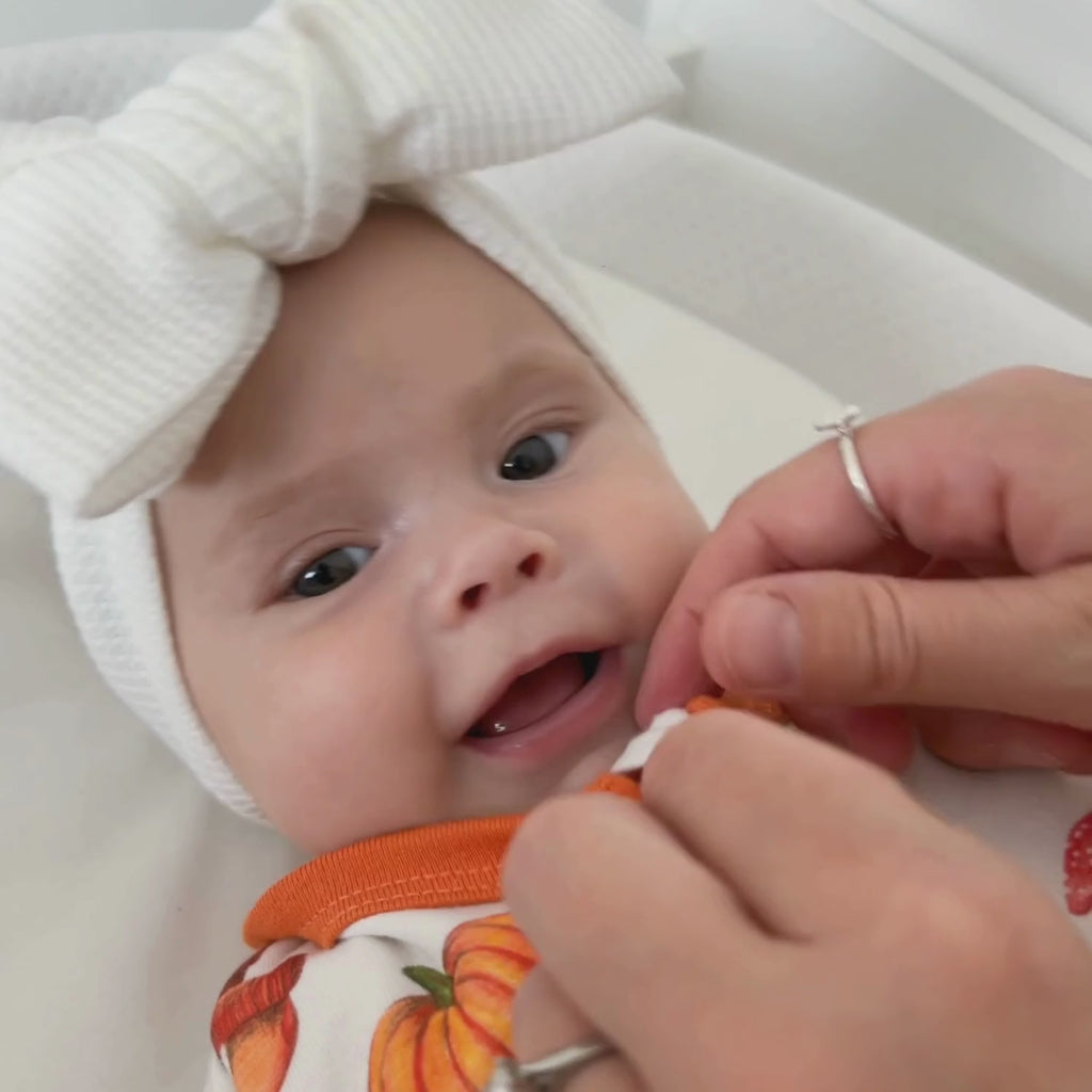 Close up on mum unzipping the GrowGrows Autumnal Amazes Organic  Sleepsuit while baby wriggles | Baby Grows and Onesies | Organic Baby Clothes - Clair de Lune UK