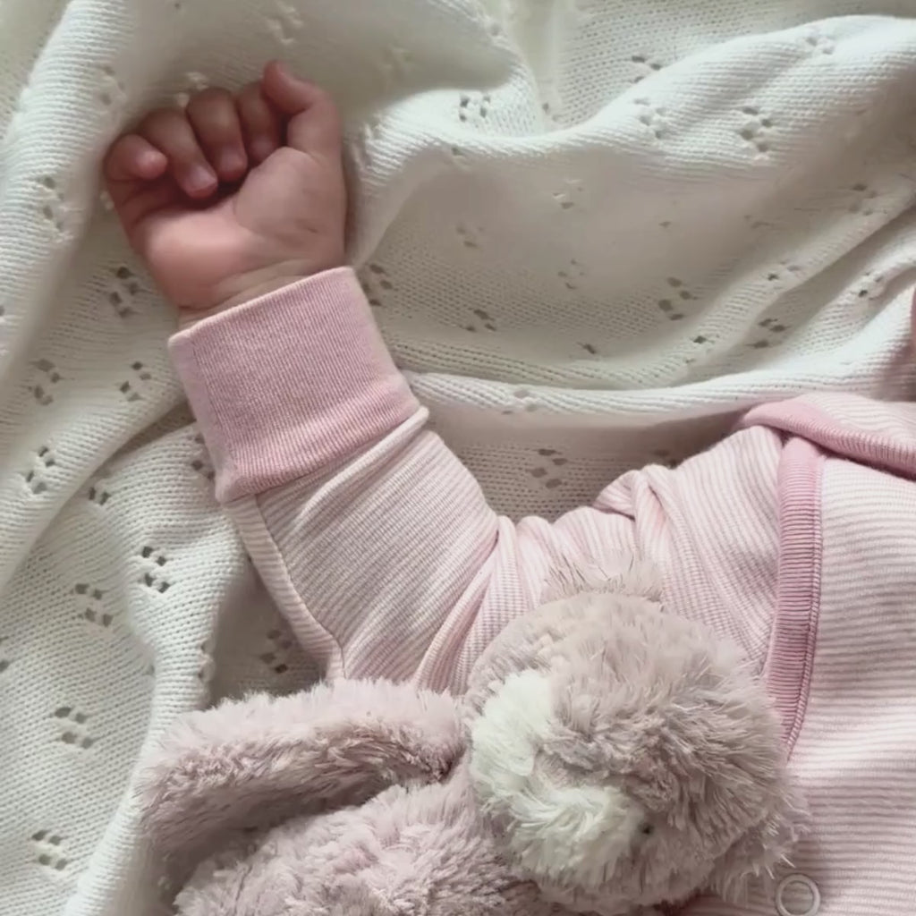 Baby wearing the Pink Organic Grow Grows Pin Stripe Smart Sleeping Bag with key features | Baby Sleeping Bags | Baby Bedding - Clair de Lune UK