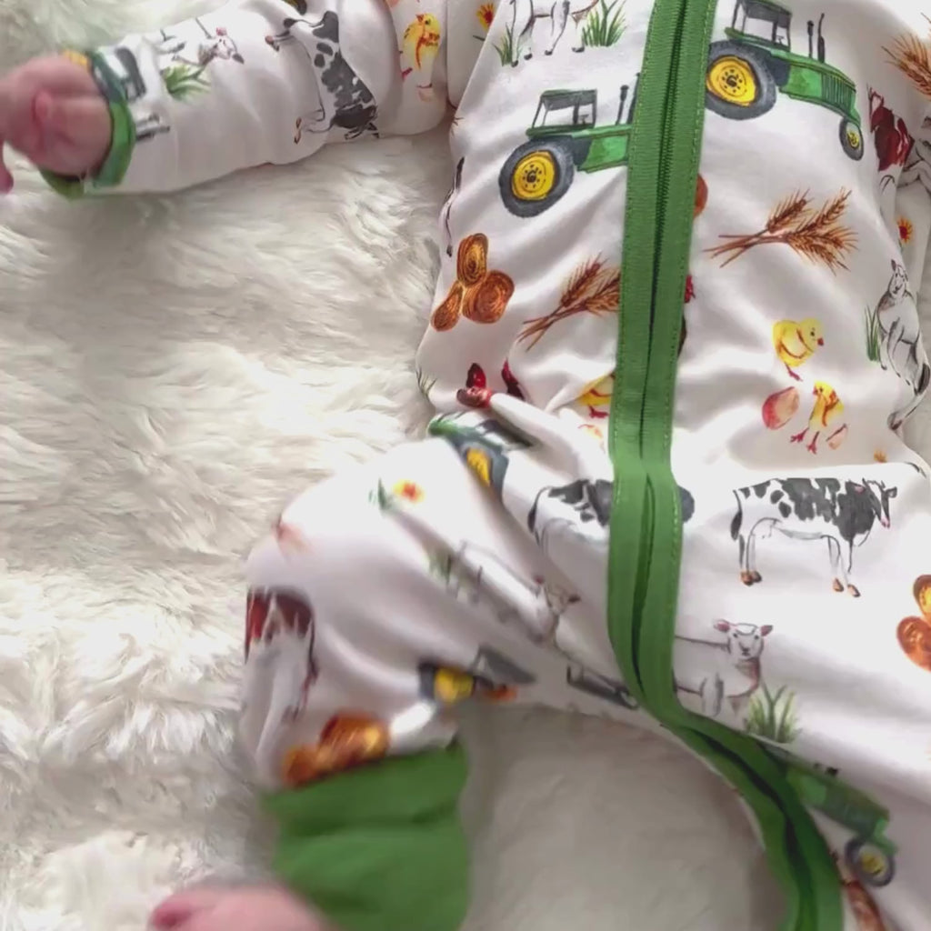 Baby wearing the Grow Grows Organic Family Farm Sleepsuit on white background | Baby Grows and Onesies | Organic Baby Clothing - Clair de Lune UK
