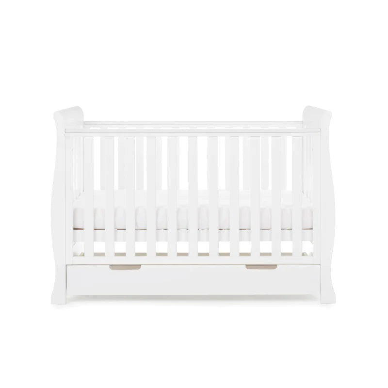 The cot bed of the White Obaby Stamford Mini 3 Piece Room Set with the adjustable platform on the medium level | Nursery Furniture Sets | Room Sets | Nursery Furniture - Clair de Lune UK