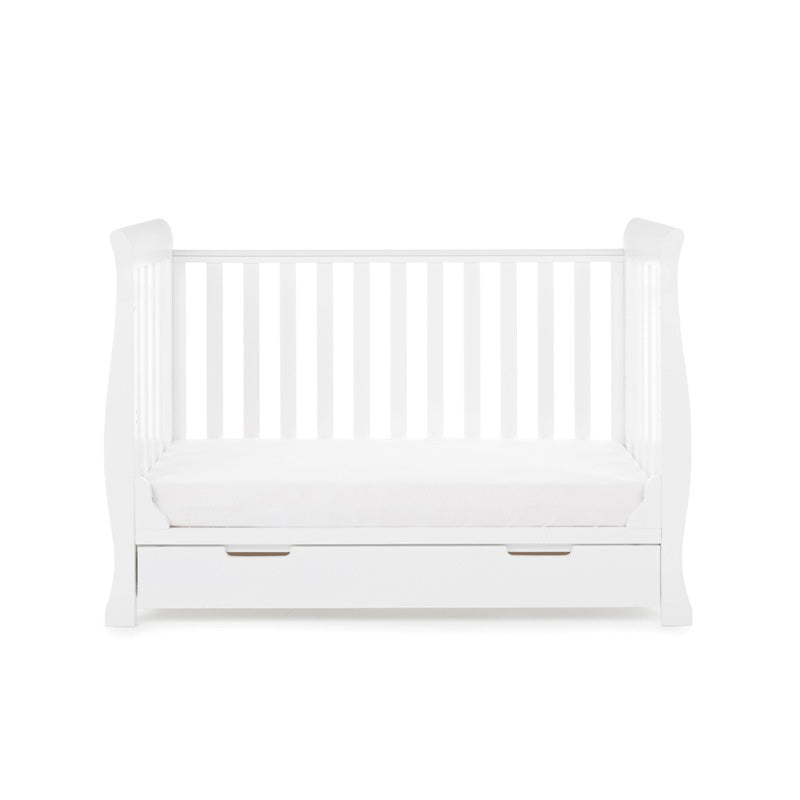 The cot bed of the white Obaby Stamford Mini Sleigh Cot & Changing Unit without a side wall | Nursery Furniture Sets | Room Sets | Nursery Furniture - Clair de Lune UK